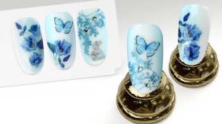 Flower and butterfly manicure in blue shade