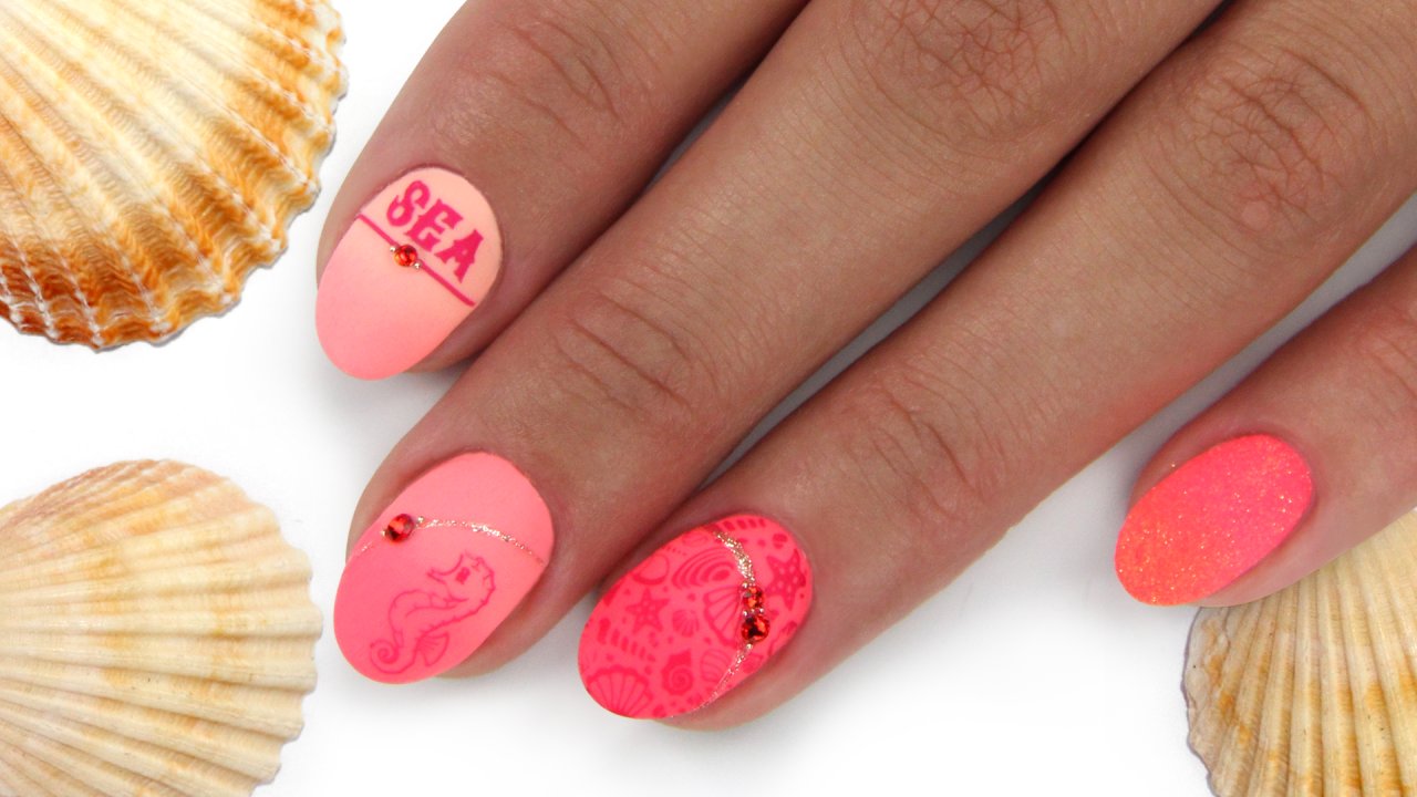 Summer salon nails in coral colour with stamping
