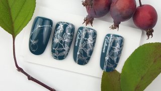 Nail art with chrome silver, stamped apple motif