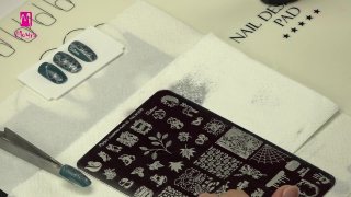 Nail art with chrome silver, stamped apple motif