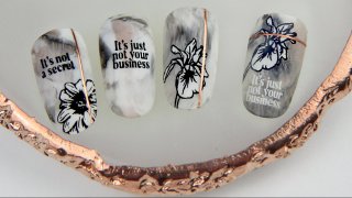 Floral and inscripted nail art idea on marble base