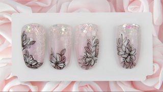 Floral nail art on a sparkling glitter ombre base