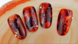 Red, marble nail art effected with nail foil