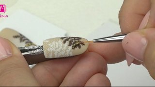 Nail art with stones, beads and fern leaf motives