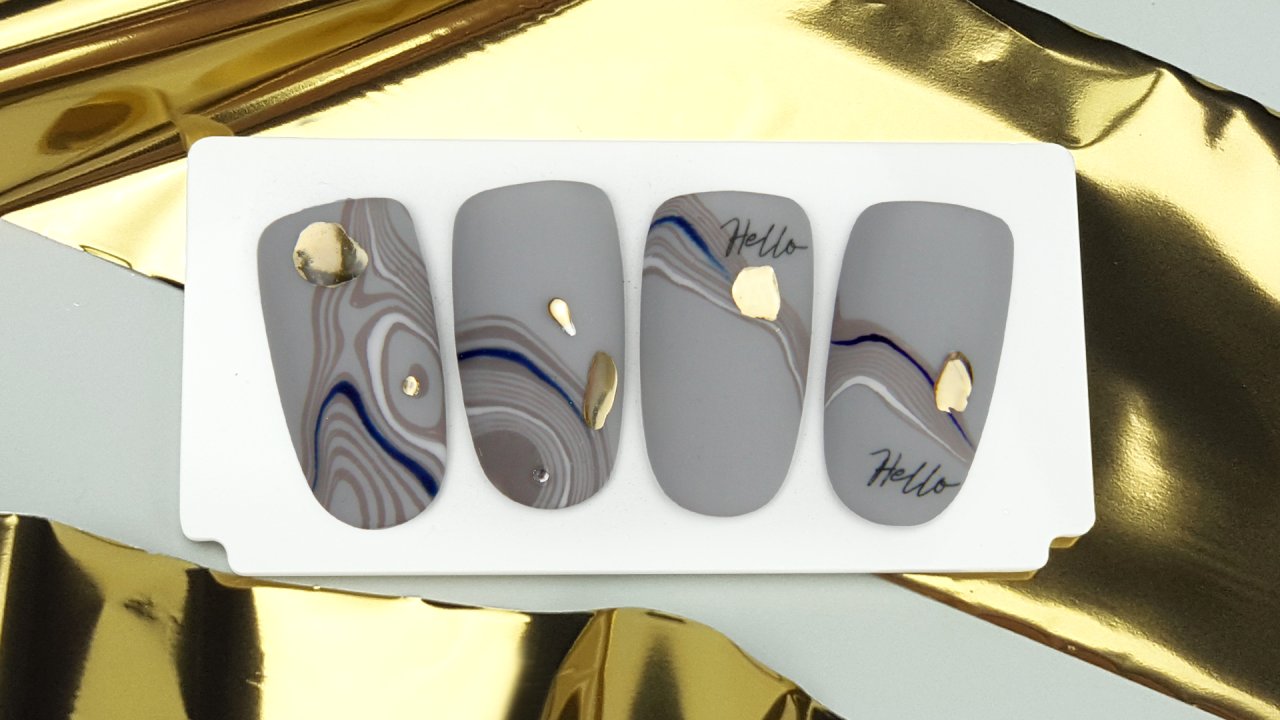 Trendy nail art with wave motif effected with foil
