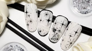 Hand-painted nail art with stars and snowflakes
