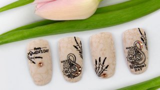Nail art for Women's Day with flowers and stones