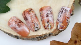 Deer nail art with autumn colours and patterns