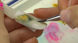 Hand-painted marble nail art with gold glittering