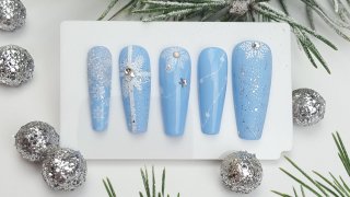 Festive nail art on light blue base