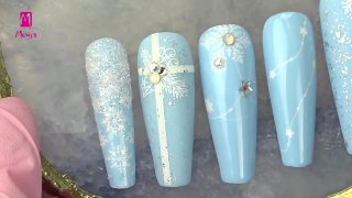 Festive nail art on light blue base - Preview