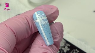 Festive nail art on light blue base