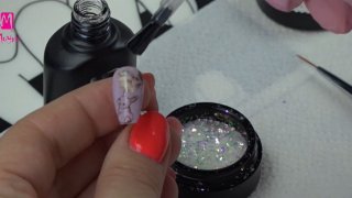 Easter nail art with bunny, flower and magic flake