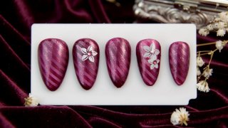 Striped nail art with plumeria flowers